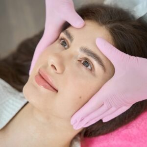 Beauty salon customer is getting facial massage