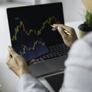 Businessman trading stocks with laptop talking about forex on laptop screens of stock market investm