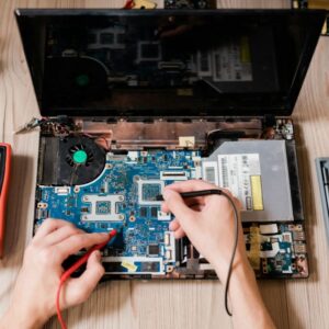 Hands of contemporary master using small soldering-irons to repair broken laptop