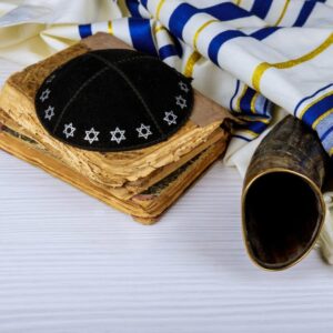 Hebrew handwritten Torah, on a synagogue alter, with Kippah and Talith shofar ram's horn