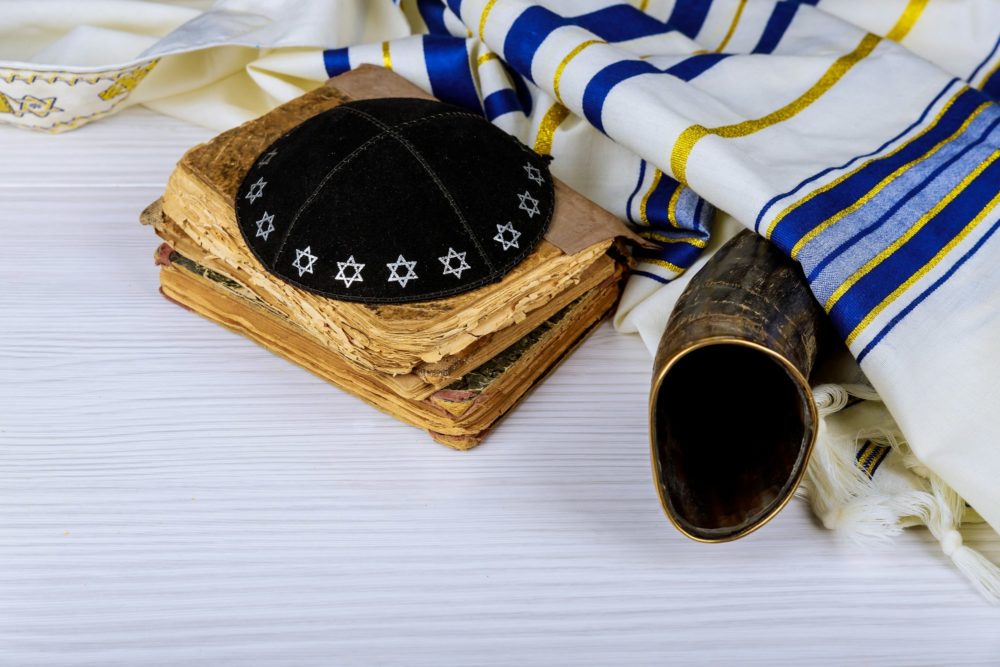 Hebrew handwritten Torah, on a synagogue alter, with Kippah and Talith shofar ram's horn