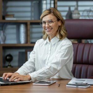 Portrait of a senior beautiful businesswoman, realtor, broker, real estate agent sitting in the