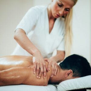 Sports massage. Therapist doing shoulder massage