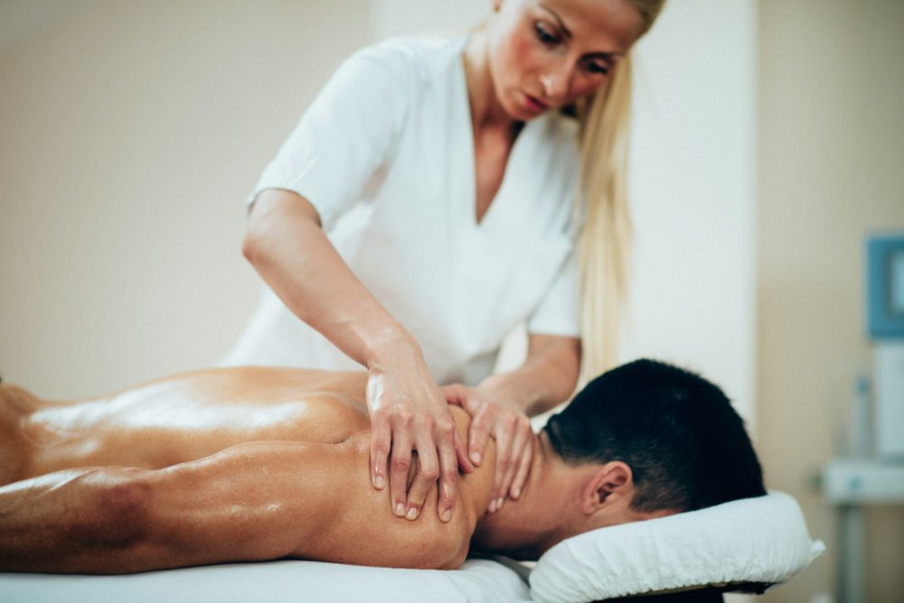 Sports massage. Therapist doing shoulder massage